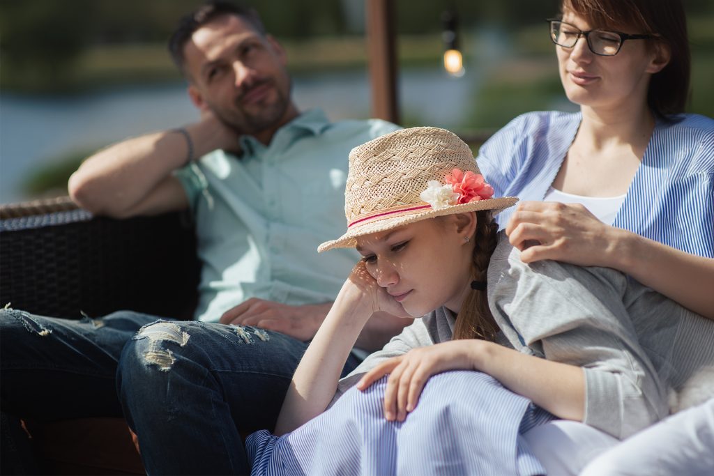 Parents and teen sitting together - parent-teen counselling and family conflict resolution