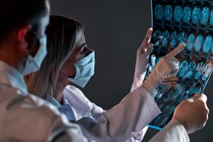 Medical professionals reviewing brain scans representing EMDR therapy for traumatic brain injury recovery