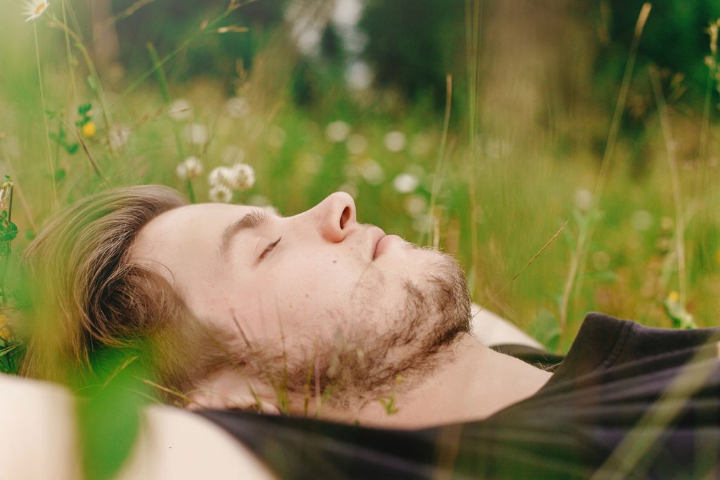 Man resting peacefully outdoors with eyes closed — representing calm and recovery through counselling services at Charlaine Robinson & Associates in Abbotsford