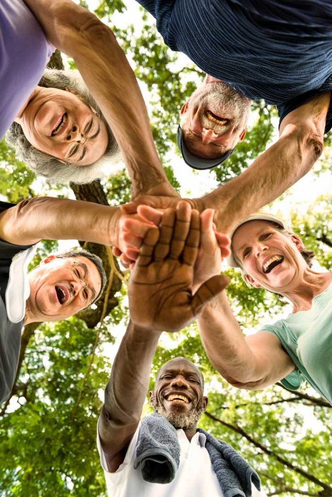 Diverse group of adults laughing and connecting — representing the wide range of people who seek counselling and therapy support in Victoria and Greater Victoria